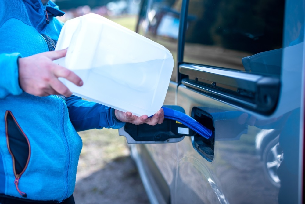 Containers of Diesel Exhaust Fluid (DEF) stored safely in a temperature-controlled environment during summer.