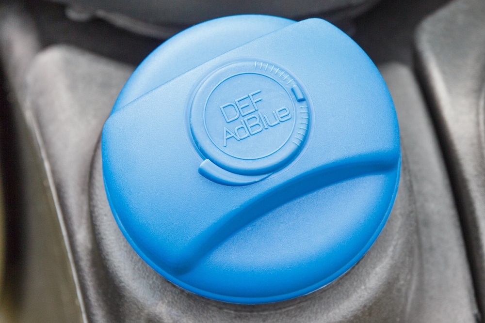 A person refilling AdBlue in a diesel car tank.