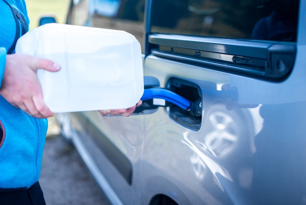 A person refilling AdBlue in a diesel car tank.