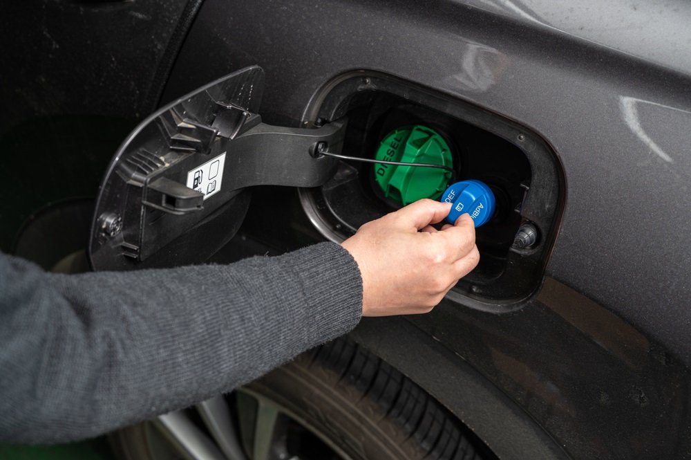 Azure Chemical AdBlue Diesel Exhaust Fluid product on a truck engine.