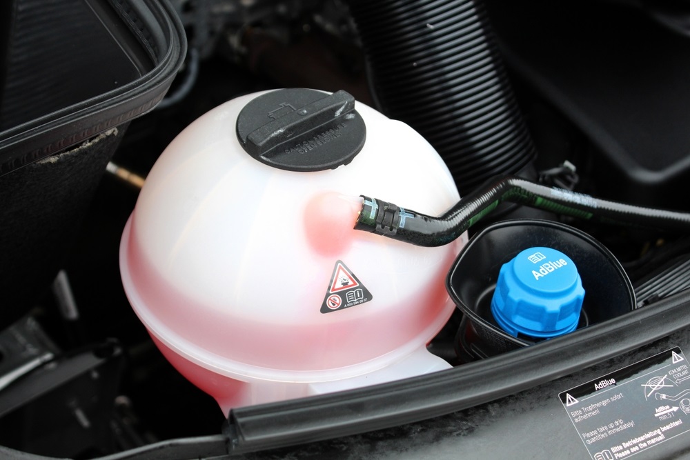 Diesel car being refilled with AdBlue for emissions control.