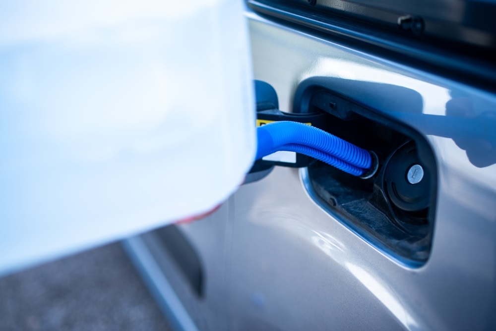 Mercedes BlueTEC diesel vehicle being refueled with AdBlue DEF fluid.