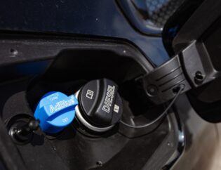 Diesel truck with DEF system and fuel tank, emphasizing the importance of using correct DEF products.