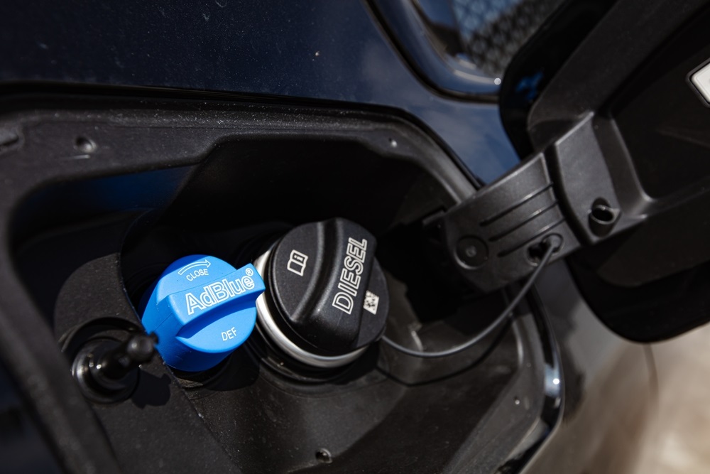 Diesel truck with DEF system and fuel tank, emphasizing the importance of using correct DEF products.