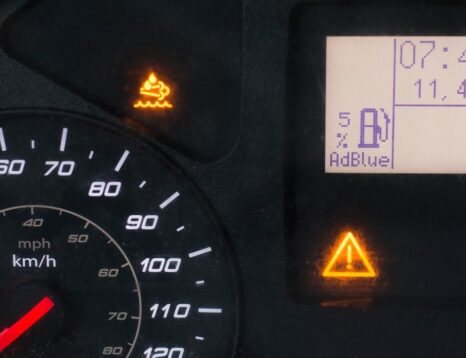 Car dashboard showing AdBlue warning light being reset after refill