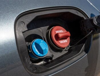 Mechanic inspecting a diesel engine AdBlue injector and SCR system.