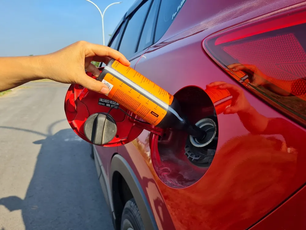 Technician examining high-purity diesel exhaust fluid in a production facility